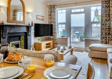 1 Dolphin Court, Woolacombe is a spacious ground-floor apartment in a Victorian building, featuring a private terrace with sea views, two bright bedrooms, and direct access to Woolacombe's award-winning golden sands just 450 metres away.