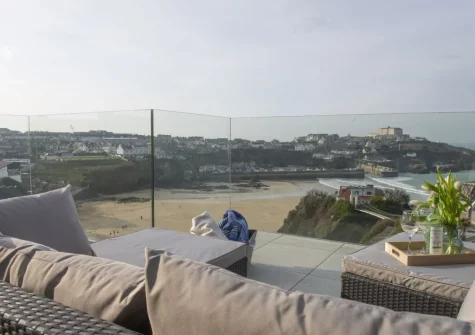 The balcony & outdoor sitting area, boasts far-reaching views across Newquay Bay, at 1 Island Reach, Newquay