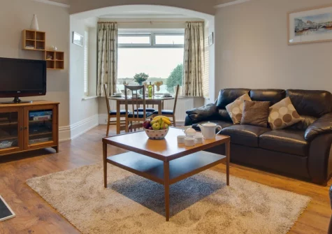 1 Pentyre House, Padstow is a chic ground-floor apartment in a Victorian house right in the heart of this celebrated fishing town, featuring stunning estuary views from the shared decking, sophisticated coastal interiors, and a private parking space.