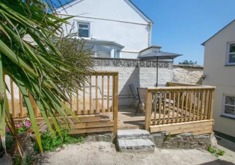 The enclosed coutyard with decked terrace & outdoor sitting area at 1 Peverell Cottages, Porthleven