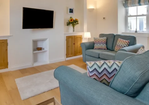 1 Peverell Cottages, Porthleven is a beautifully updated traditional cottage just metres from stunning sandy beaches, featuring a sunny raised decked terrace, original character features, and easy access to the harbour and coastal paths.