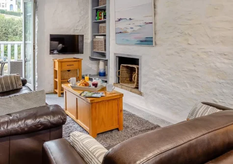1 Riverview, Looe, is a stunning quayside cottage with river views, just yards from sandy beaches. Enjoy boutique interiors, a private balcony, and easy access to Cornwall's south coast attractions, perfect for memorable family breaks.