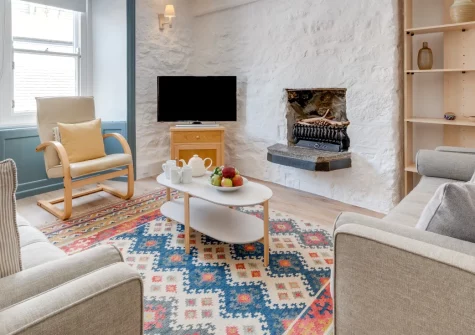 10 Porthmeor Square, St Ives is a characterful stone cottage in historic Downalong, featuring a rooftop sunroom and terrace with sea views, just steps from Porthmeor Beach, the harbour and Tate St Ives in this vibrant artistic town.