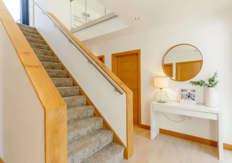 The hallways & stairs up to the first floor at 11 Beachdown, Challaborough