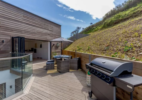 The decked terrace, barbecue & alfresco dining area at 11 Beachdown, Challaborough