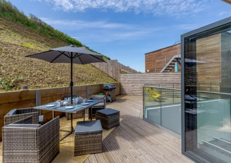 The decked terrace, barbecue & alfresco dining area at 11 Beachdown, Challaborough