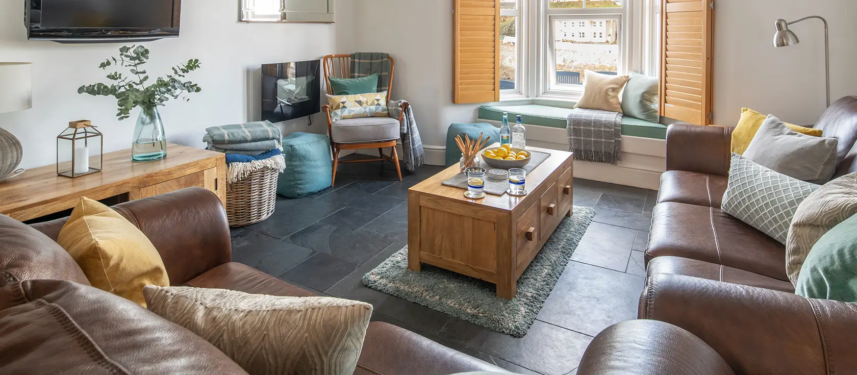 12 Bay View, Porthleven is a stylish 3-bedroom Victorian cottage with stunning harbour views. Enjoy cosy interiors, window seat, private patio, and easy access to Cornwall's finest beaches, restaurants, and coastal attractions - perfect for families.