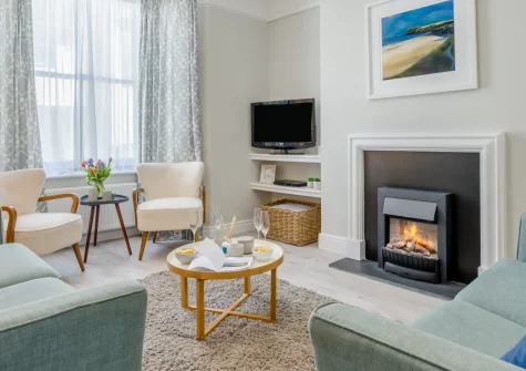 12 New Street, Padstow is a captivating three-storey townhouse in the heart of this harbour town, featuring four bedrooms, dual lounges, a sun-trap terrace with estuary views, and easy access to North Cornwall's beaches and the Camel Trail.