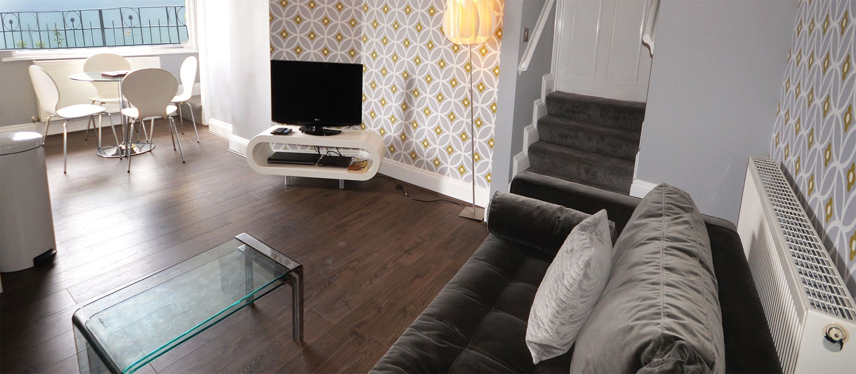 15 Astor House, Torquay is a stylishly decorated two bedroom apartment with superb sea views from the living room & balcony. Modern open kitchen, marble bathroom & shared gardens near Torre Abbey Sands, marina, waterfront restaurants & Princess Theatre.