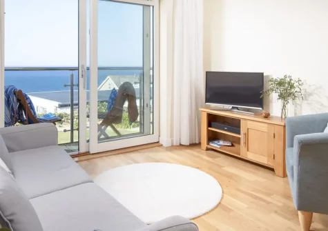 15 The Sands, Carbis Bay is a stunning 2-bedroom apartment with spectacular sea views and private balcony. Just minutes from golden sands and the artistic haven of St Ives, this coastal retreat offers the perfect base for memorable family holidays.