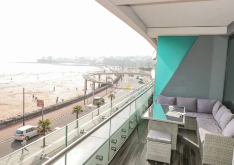 Enjoy far-reaching sea views from the balcony & alfresco dining area at 18 Abbey Sands, Torquay
