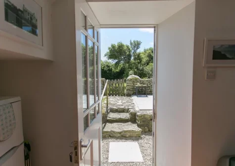 Step out onto the large patio, alfresco dining area & garden at 2 The Chapel, Rinsey