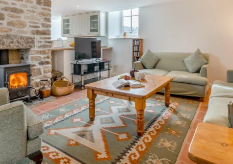 2 The Chapel, Rinsey is a characterful 2-bedroom chapel conversion in peaceful countryside near the coast, featuring a wood burner, sun-drenched patio, tranquil gardens, and easy access to Rinsey Cove and the stunning South West Coast Path.