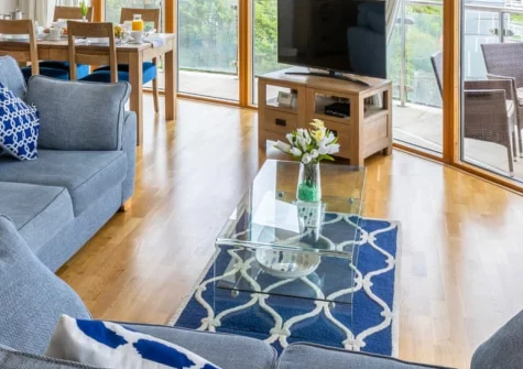 Apartment 22 at Horizon View, Westward Ho! is a contemporary two-bedroom first-floor retreat commanding spectacular Golden Bay views, featuring a wraparound balcony, stylish interiors, and direct beachfront access to North Devon's surf and sand.