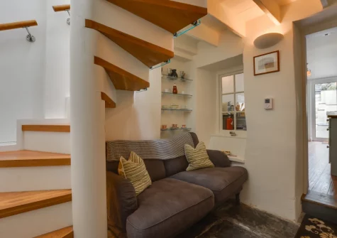 The cozy snug & stairs up to the first floor at 26 Church Lane, Padstow