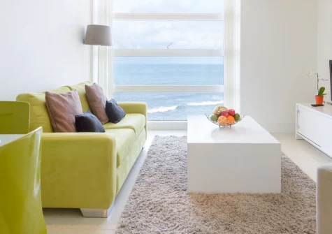 28 Rocklands, Newquay is a stylish first-floor apartment boasting panoramic views over Tolcarne Beach, a sea-view dining area, underground parking and a storage locker for beach gear, ideal for a relaxing seaside escape with direct beach access.