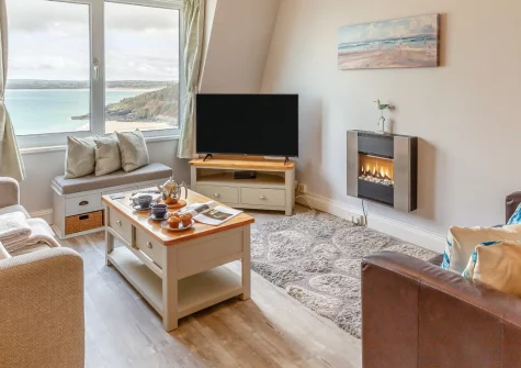 46 Carrack Widden, St Ives is a contemporary apartment positioned right above Porthminster Beach's golden sands, featuring spectacular sea views towards Godrevy Lighthouse, coastal-inspired interiors, and the vibrant heart of St Ives close by.