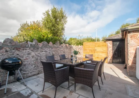The courtyard garden patio , barbecue & alfresco dining area at 5 Coastguard Cottages, Torquay