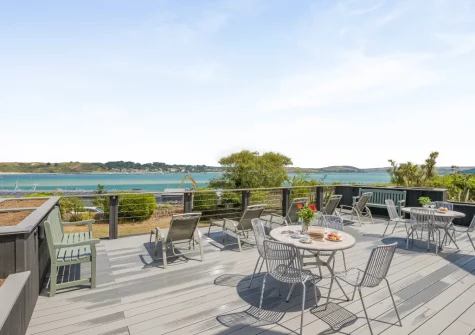The shared decked terrace, alfresco dining & outdoor sitting area at 5 Pentyre House, Padstow