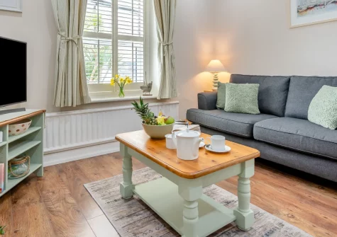 5 Pentyre House, Padstow is a romantic first-floor apartment in a grand Victorian house, with estuary views from its private decking, stylish open-plan living, a cosy double bedroom, and Padstow's harbourside charms just a short stroll away.