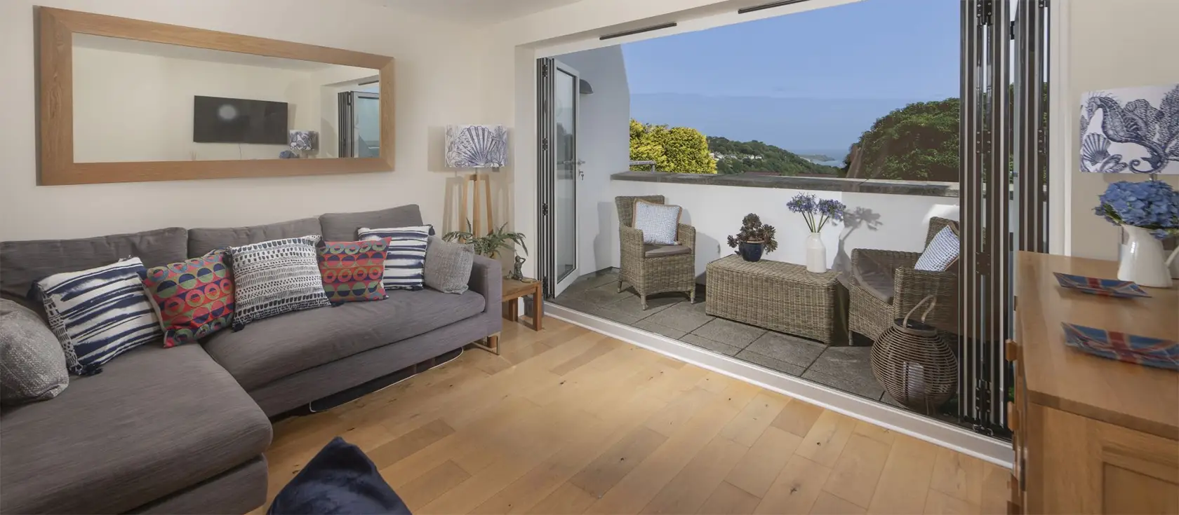 5 Sandy Lane Apartments, Carbis Bay is a lush two-bedroom coastal retreat with stunning sea views, offering modern comforts, private balconies, and easy access to beautiful beaches and charming Cornish towns, perfect for a memorable seaside escape.