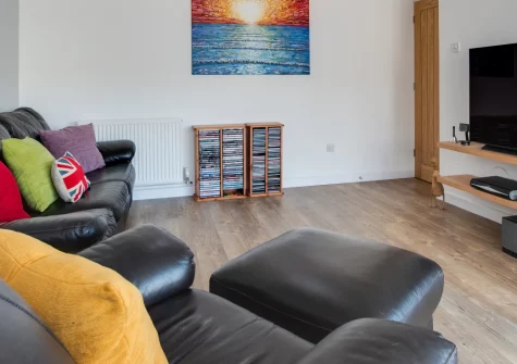 5 The Fairway, Braunton is a thoughtfully designed two-bedroom bungalow in peaceful North Devon, featuring a fairy-lit courtyard garden, jewel-toned interiors, secure surfboard storage, and easy access to Saunton Sands and Croyde Bay beaches.