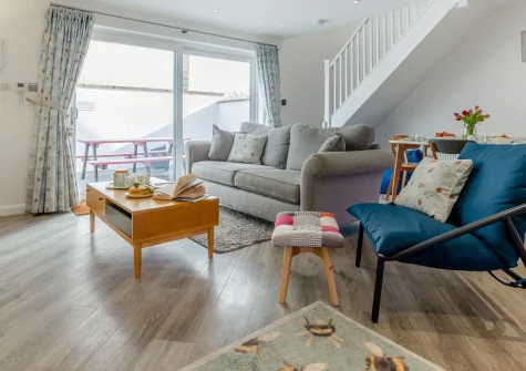 50 Padstow, Padstow is a stylish two-bedroom cottage in the heart of this historic fishing port, featuring contemporary interiors, a private enclosed patio, and allocated parking, all within an easy stroll of the harbour and North Cornwall beaches.