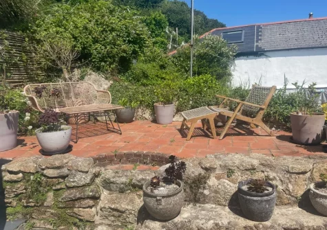 The tiered rear patio garden & outdoor sitting area at 8 Millpool, Mousehole