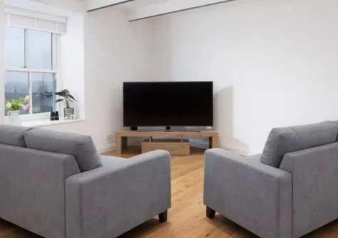 80 Fore Street, Newlyn is a characterful three-bedroom cottage set directly opposite the working harbour, featuring contemporary interiors with Japanese-inspired design touches, stunning sea views, and the charm of the lovely fishing village.