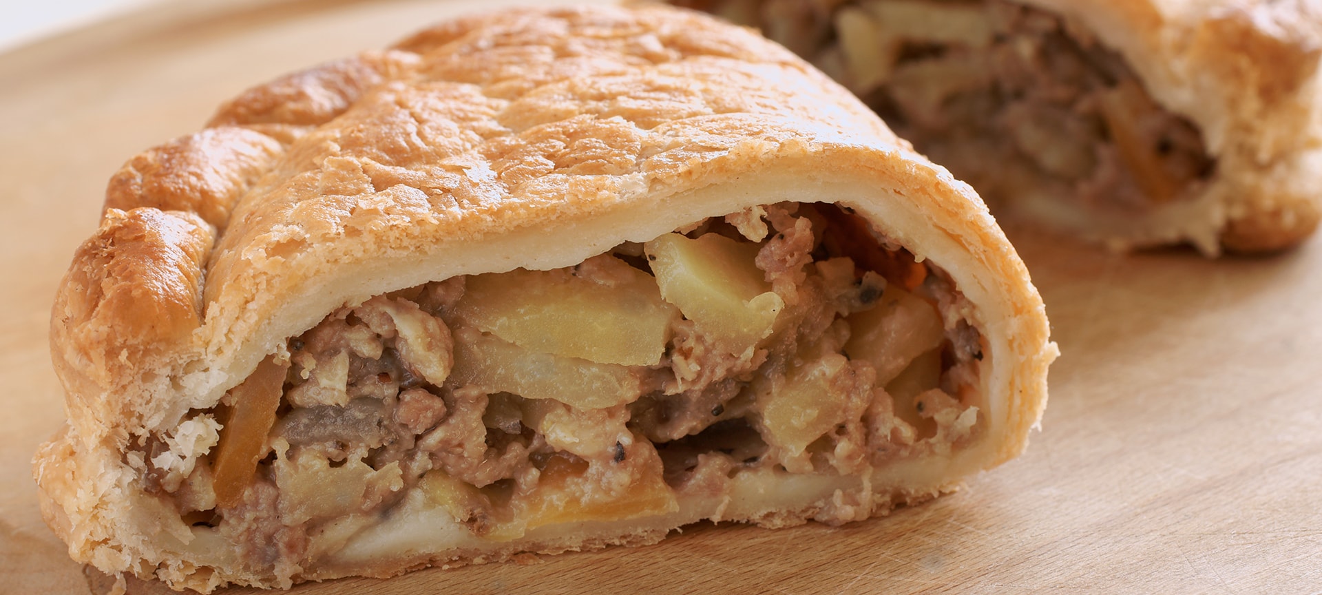 Cornish pasties are a meal in themselves. The semi-circular pastry case (shaped to slip into a miner's pocket) is crammed with potato, swede, steak and seasoning and tastes surprisingly good! The thick crimped seam was intended to be held by dirty hands and then discarded.