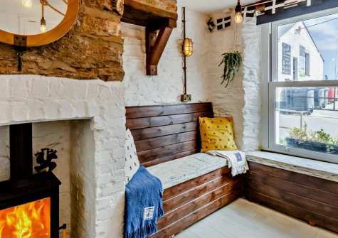 Albatross Cottage, Looe is a quirky beachfront retreat in the heart of this historic fishing town, featuring a warming wood burner, sea views from both bedrooms, private parking, and the golden sands just yards from your front door.