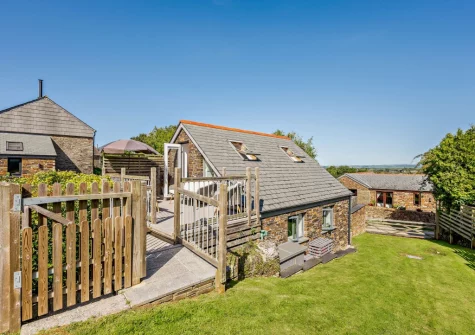 The decked terrace & outdoor sitting area leads out to the lawned garden at An Skyber, St Breock