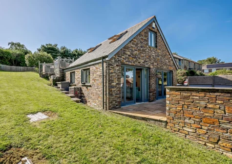 The patio, barbecue & alfresco dining area leads out to the lawned garden at An Skyber, St Breock