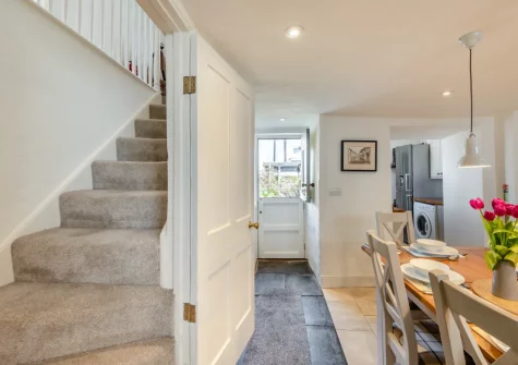 The dining area & stairs up to the first floor at Annie's Cottage, Appledore