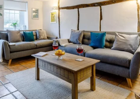 Anvil Cottage, Barnstaple is a charming 200-year-old former blacksmith's cottage retreat featuring original exposed beams, cosy wood burner, and delightful south-facing tiered garden. Perfect for families seeking authentic countryside charm.