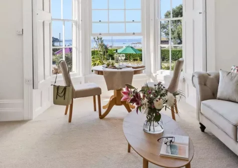 Apartment 1 at The Gew, Marazion is a spacious ground-floor apartment with sweeping sea views over St Michael's Mount, elegant Victorian character, large communal gardens, ample parking and easy access to Marazion's sandy beach and coastal path.