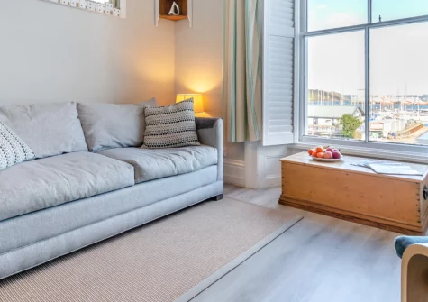 Apartment 5 at Quayside, Falmouth is a charming one-bedroom retreat in a Georgian townhouse, boasting stunning harbour views across to St Mawes, cosy modern interiors, and a short stroll to the town's beaches, shops, restaurants and ferry links.