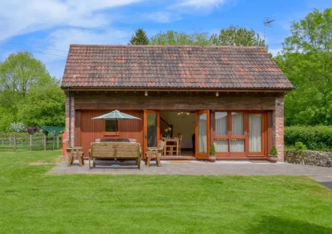 The patio, alfresco dining area & enclosed lawned garden at Apple Barrel Barn, Dunkeswell Abbey