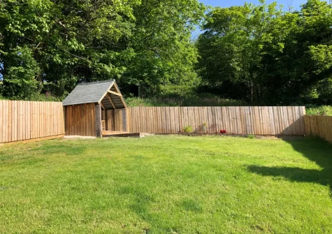 The enclosed lawned garden at April Cottage at Sanctuary Farm, Woodford