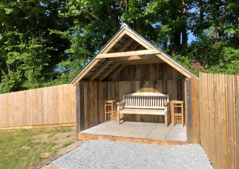 The enclosed lawned garden & outdoor sitting area at April Cottage at Sanctuary Farm, Woodford