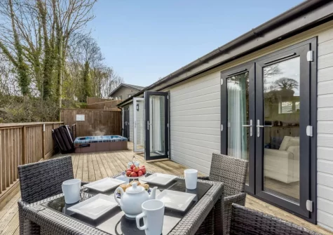 The decked terrace, alfresco dining area & sunken hot tub at Ash Lodge, The Retreat, Romansleigh