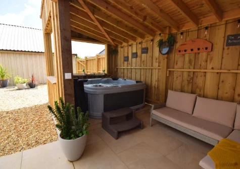 The private hot tub, perfect for use in all weathers due to its unique enclosure, at Austen Cottage, Swanmoor Grange, Harracott