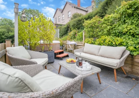 The enclosed tiered sun-trap patio & outdoor sitting area at Azalea Barn, Lee