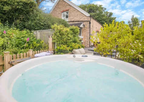The enclosed tiered sun-trap patio & hot tub at Azalea Barn, Lee