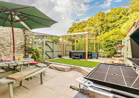 The patio, barbecue, alfresco dining area & hot tub at Badgers At Langoose, Lanhydrock