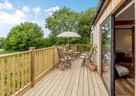 The enclosed decked wrap-around balcony & outdoor sitting area at Bailey Lodge, Barnstaple