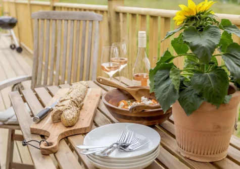 The enclosed decked wrap-around balcony, barbecue & outdoor sitting area at Bailey Lodge, Barnstaple