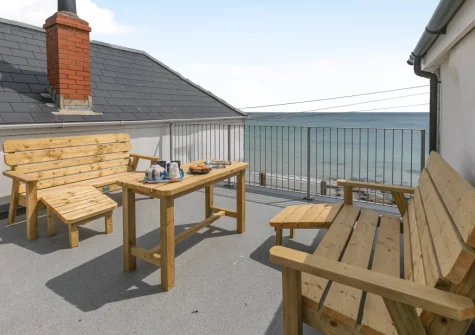 The front balcony & outdoor sitting area at Barachy, Coverack