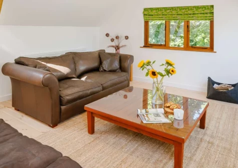 Barn at East Hele, Kings Nympton is a stunning reverse-level barn conversion set in peaceful Devon countryside, featuring a galleried living space with wood burner, private orchard access for dogs, and easy reach of Exmoor's dramatic landscapes.