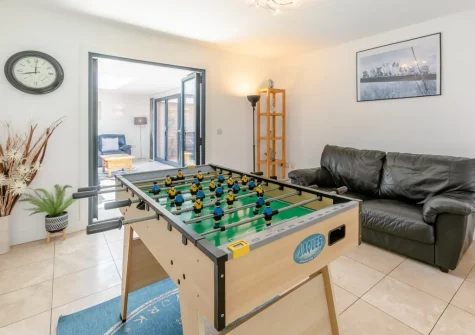 The sitting area with table football at Barn at Little Greenslade, Sampford Courteney